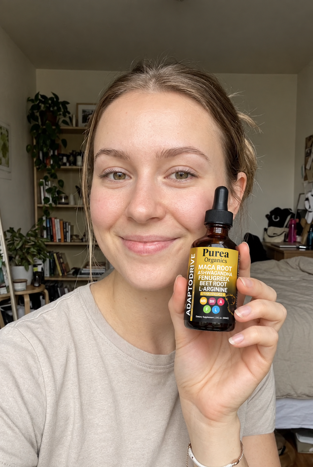 Customer holding the Purea Organics Liquid Maca Root bottle at home