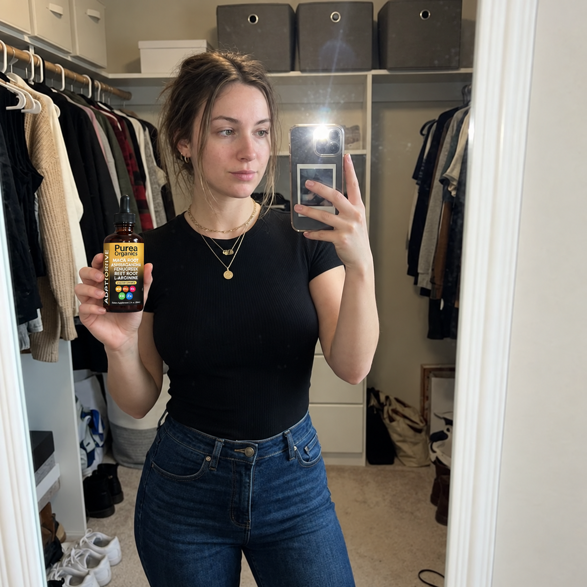 Customer mirror selfie holding the Purea Organics bottle